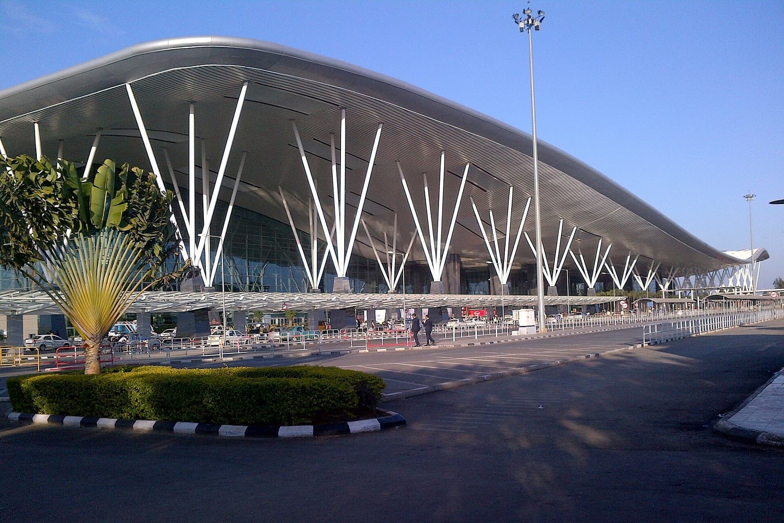 The curved roof and white column supports of the terminal at Kempegowda International Airport, Bengaluru