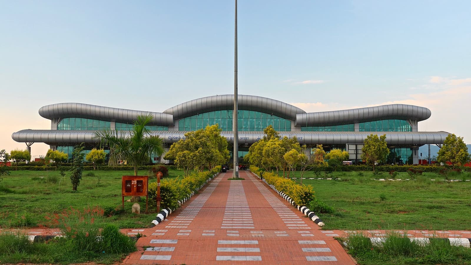 The terminal building of Mysuru Airport at the end of a paved garden path
