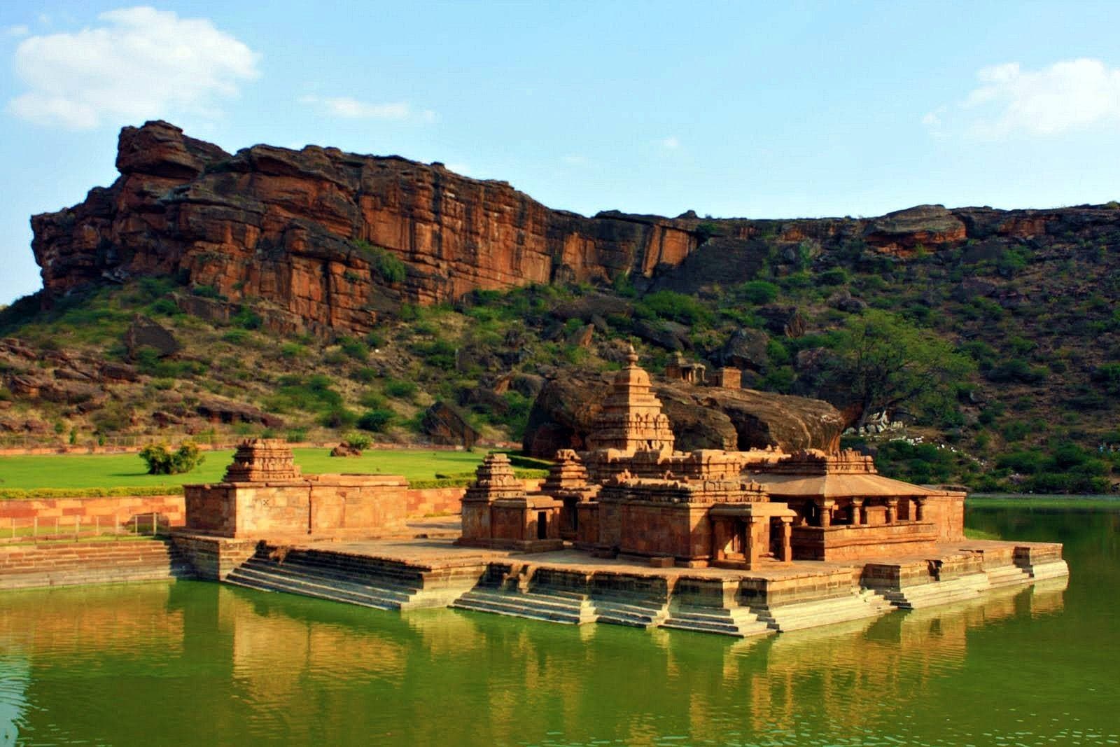 Bhutanatha temples on the shore of Agastya lake below the red sandstone cliffs of Badami