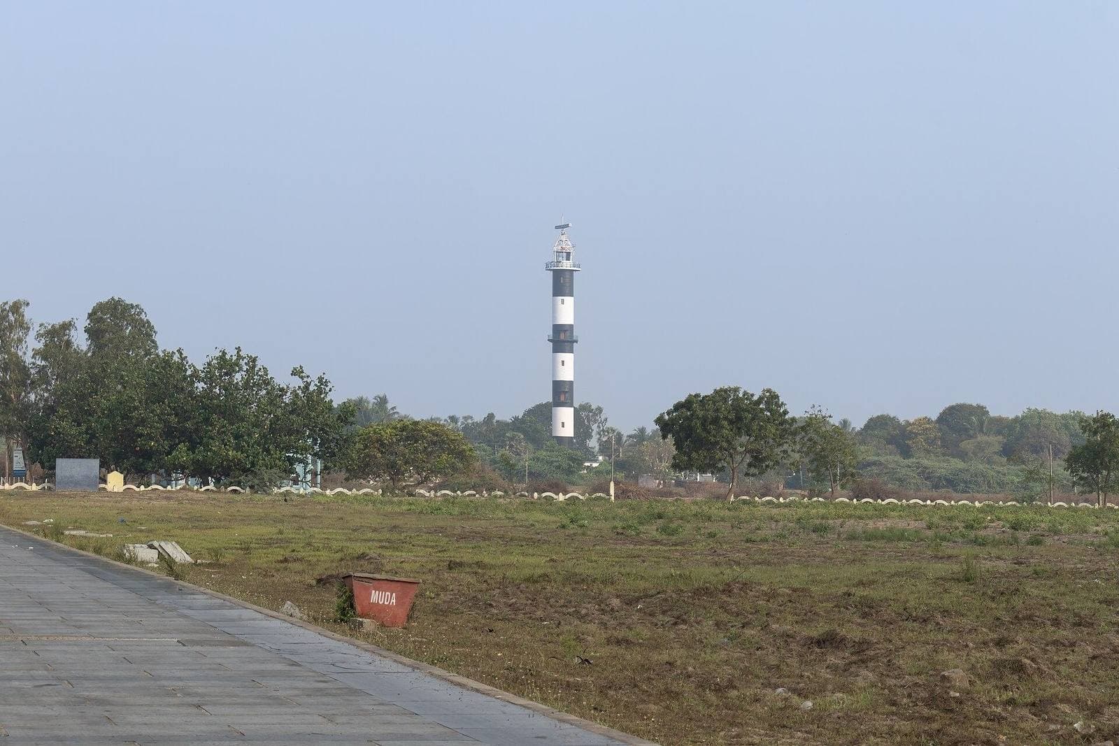 A lighthouse beyond open ground near Machilipatnam