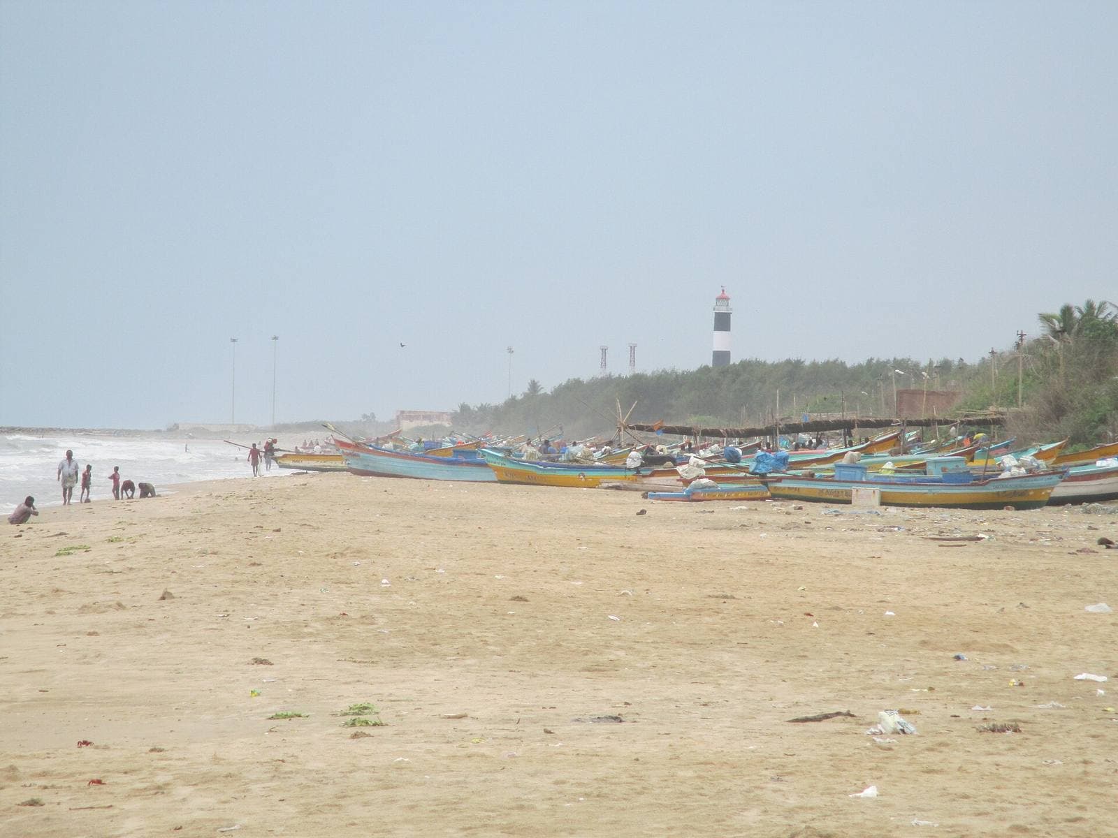 Fishing boats on the beach at Nagapattinam, with the lighthouse behind