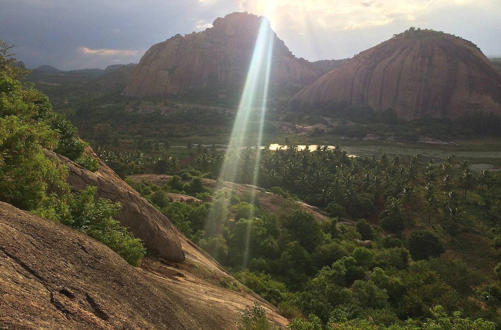 Sunlight breaking over the granite hills of Ramanagara