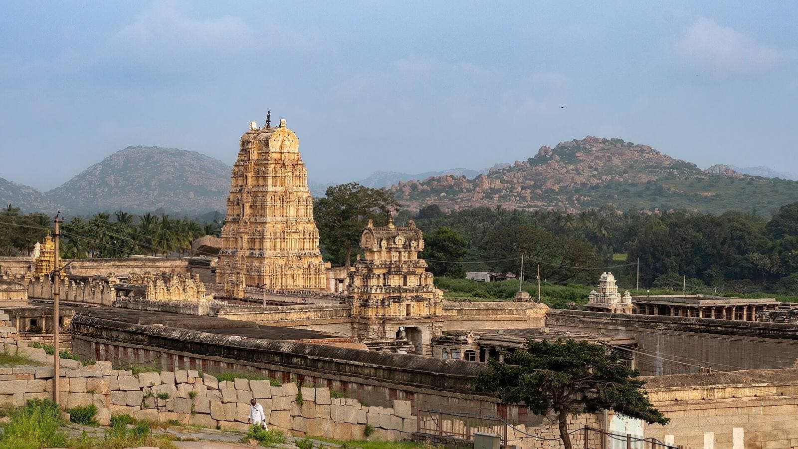The Virupaksha Temple and surrounding ruins at Hampi, with boulder hills in the distance